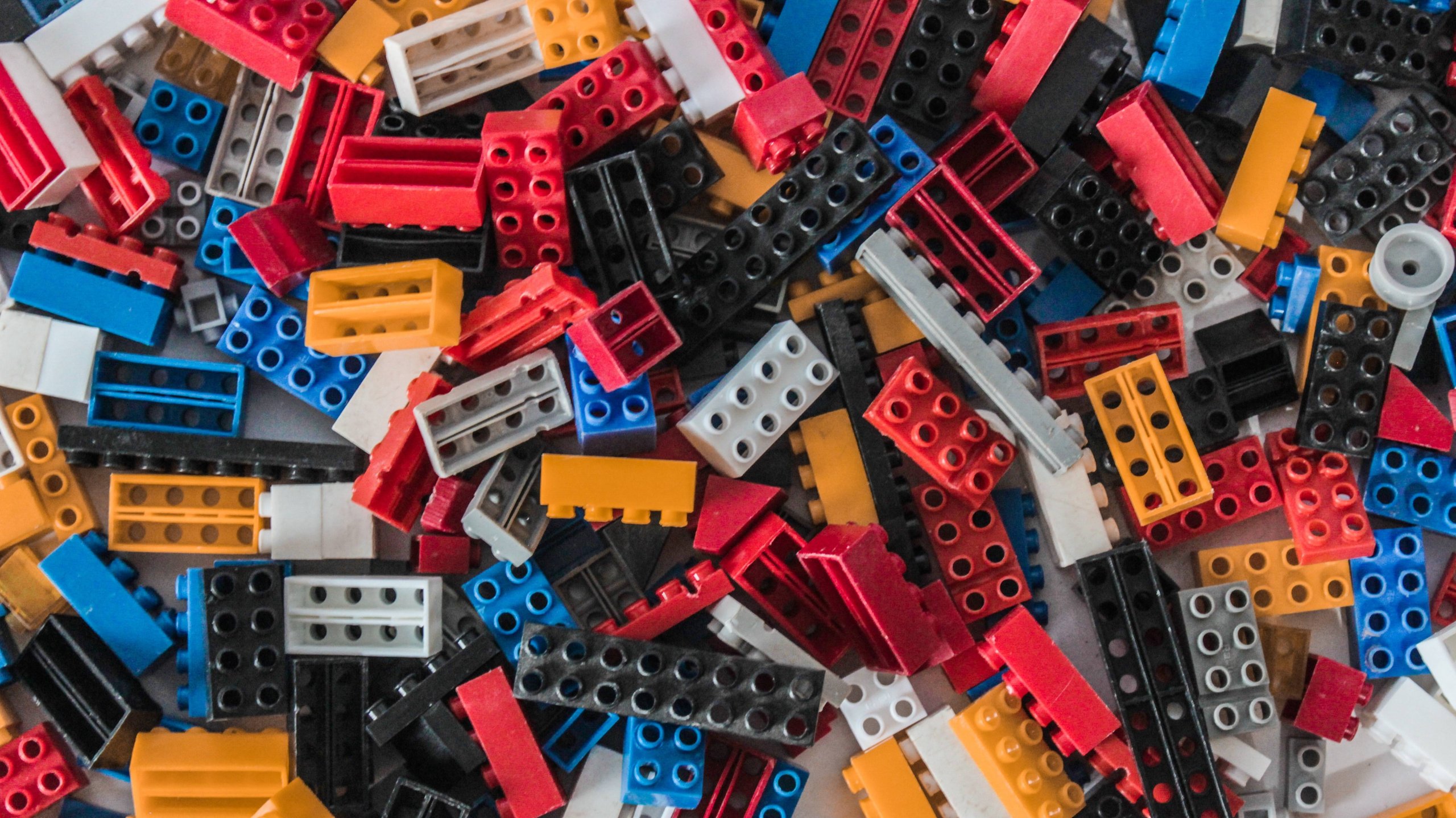 A colorful assortment of interlocking plastic bricks scattered across a surface