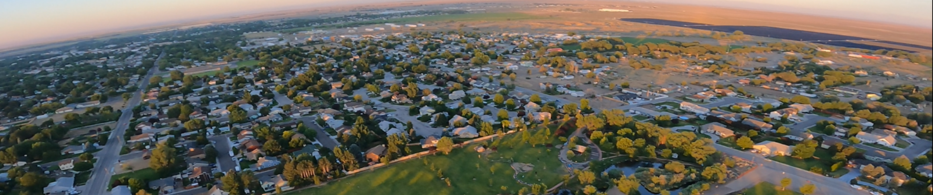 Aerial view of a sprawling suburban neighborhood with numerous houses and trees