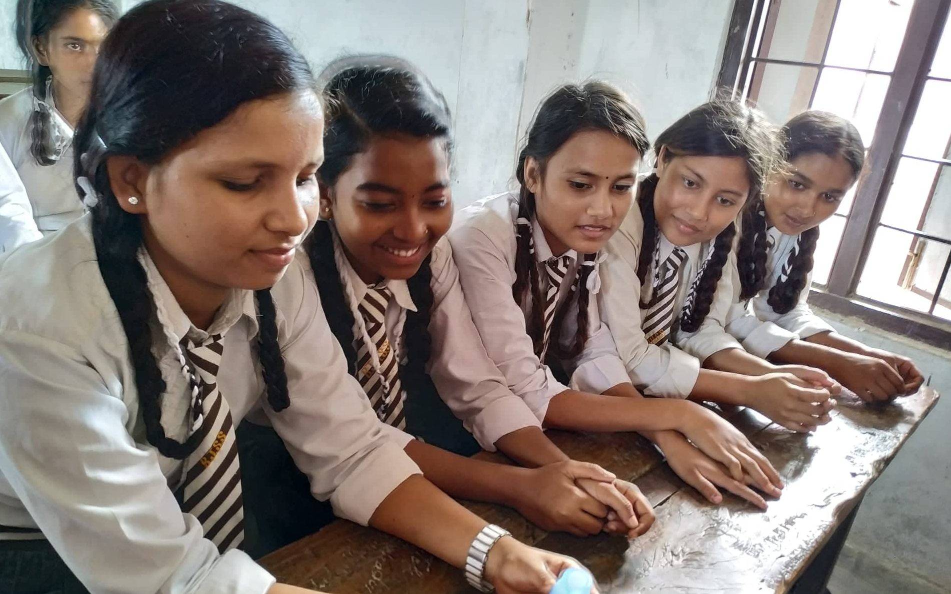 Girls hold a donated cup