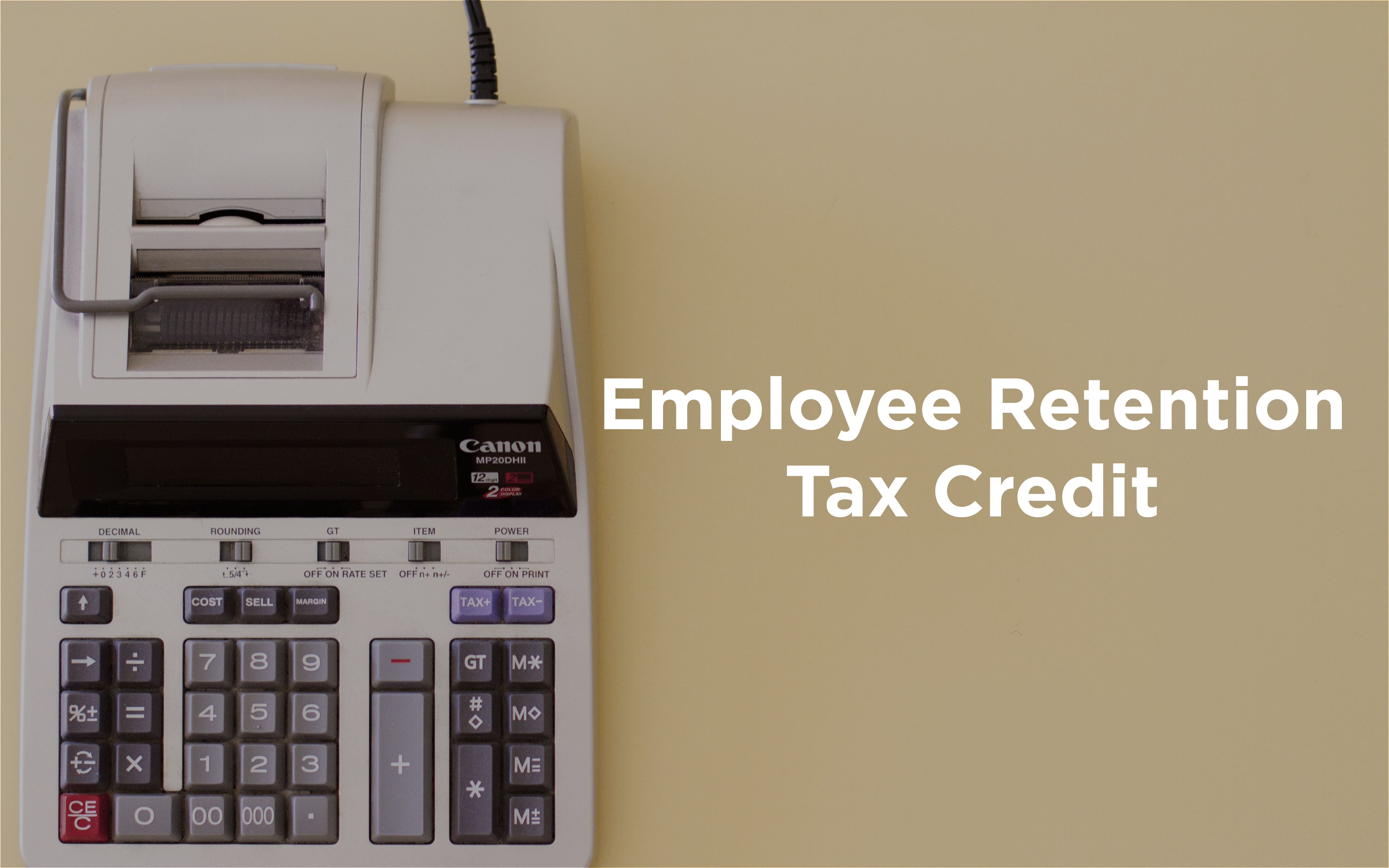 A Canon calculator sits next to text about employee retention tax credit