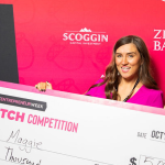 A pitch competition winner poses.