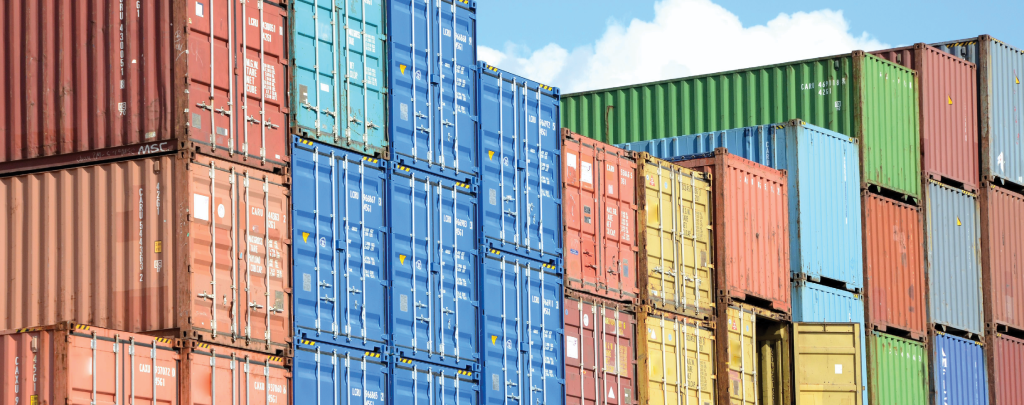 A colorful array of stacked shipping containers in various bright hues