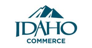 A stylized logo featuring a mountain range above the word 'IDAHO' and 'COMMERCE' below