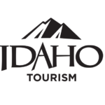 A stylized logo featuring a mountain range and the word 'IDAHO' with 'TOURISM' below