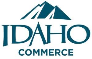 A stylized logo featuring a mountain range above the word 'IDAHO' and 'COMMERCE' below