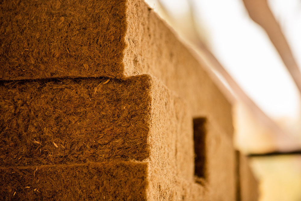 Stacked rectangular blocks of brown, fibrous material with a rough texture