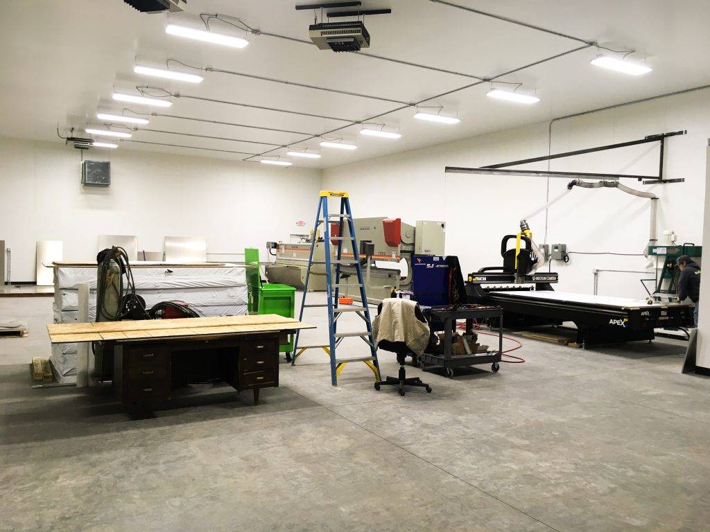 A spacious industrial workshop with various machinery and tools arranged throughout