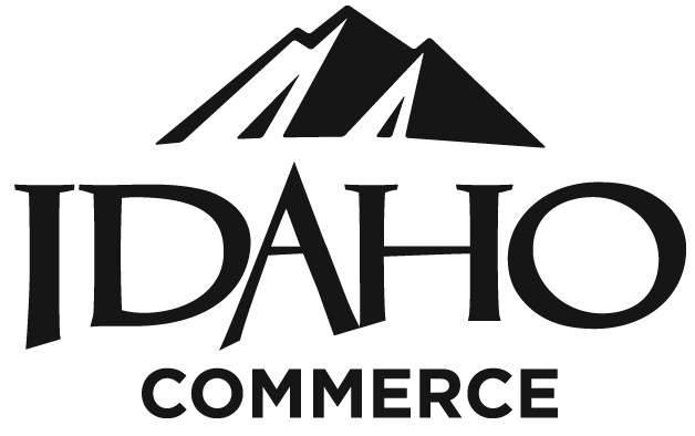 A stylized logo featuring a mountain range above the word 'IDAHO' and 'COMMERCE' below