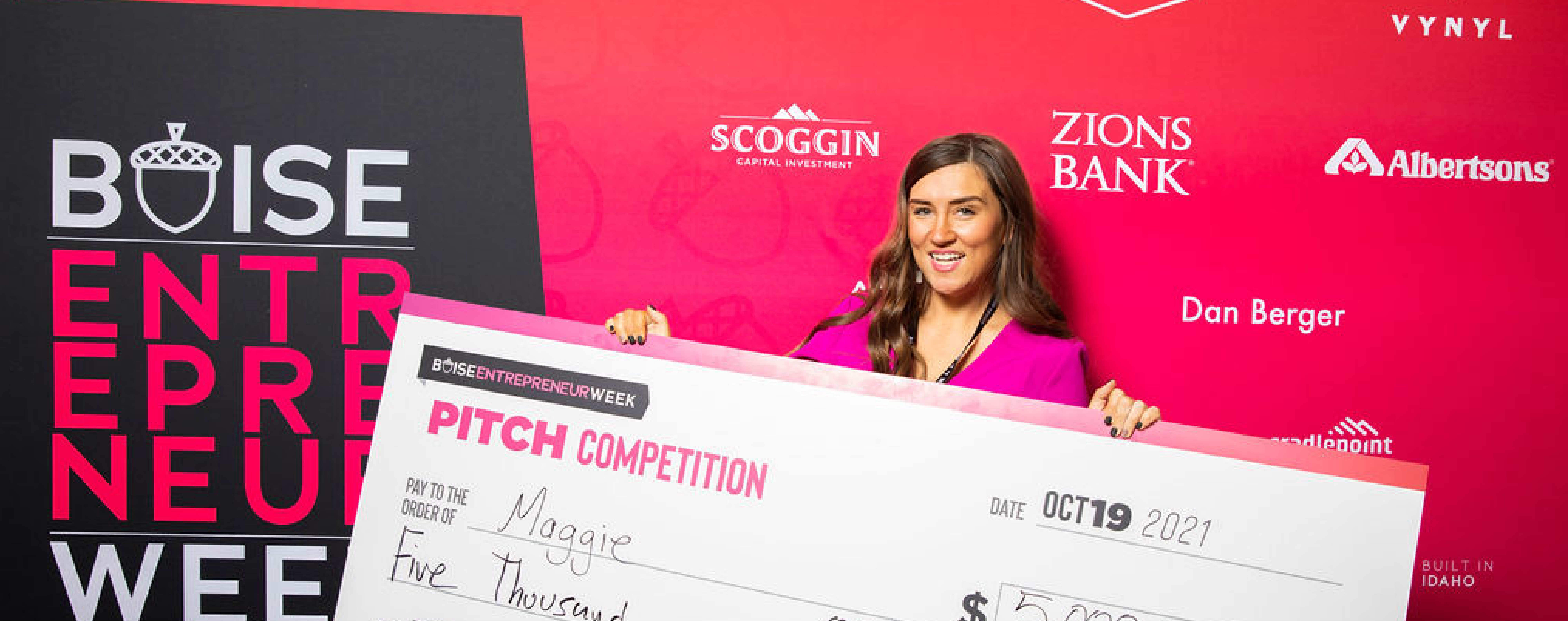 A pitch competition winner poses.