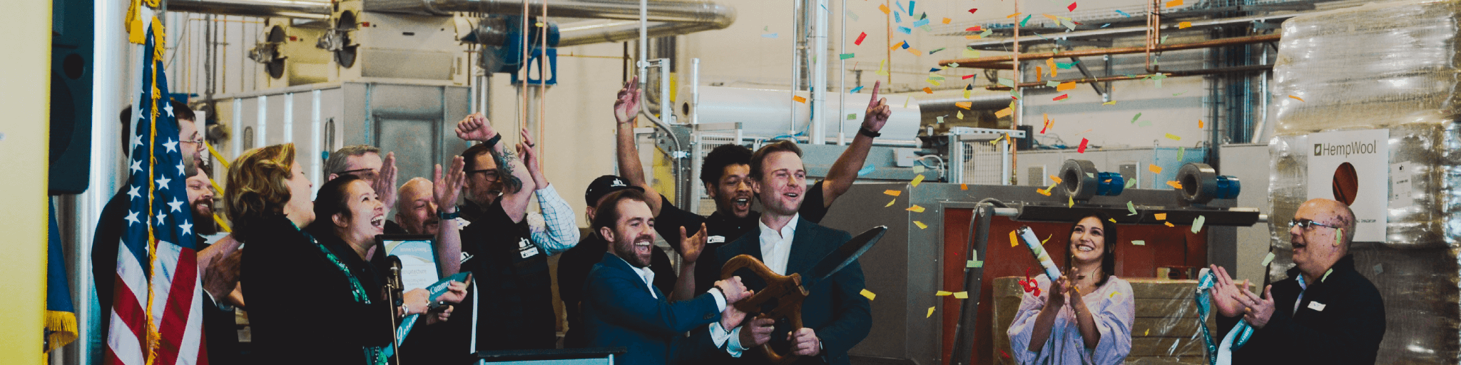 Group of people celebrating with confetti in an industrial setting