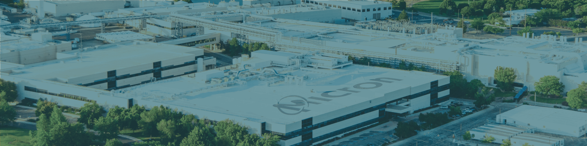 Aerial view of a sprawling industrial complex with interconnected buildings and green spaces