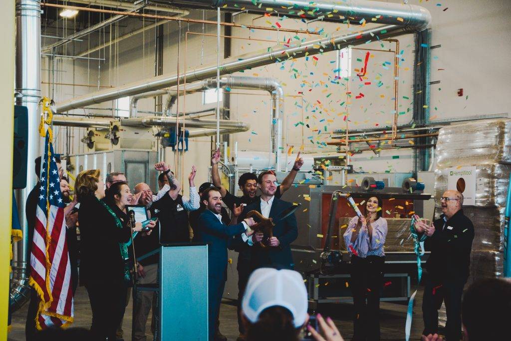 Group of people celebrating with confetti in an industrial setting