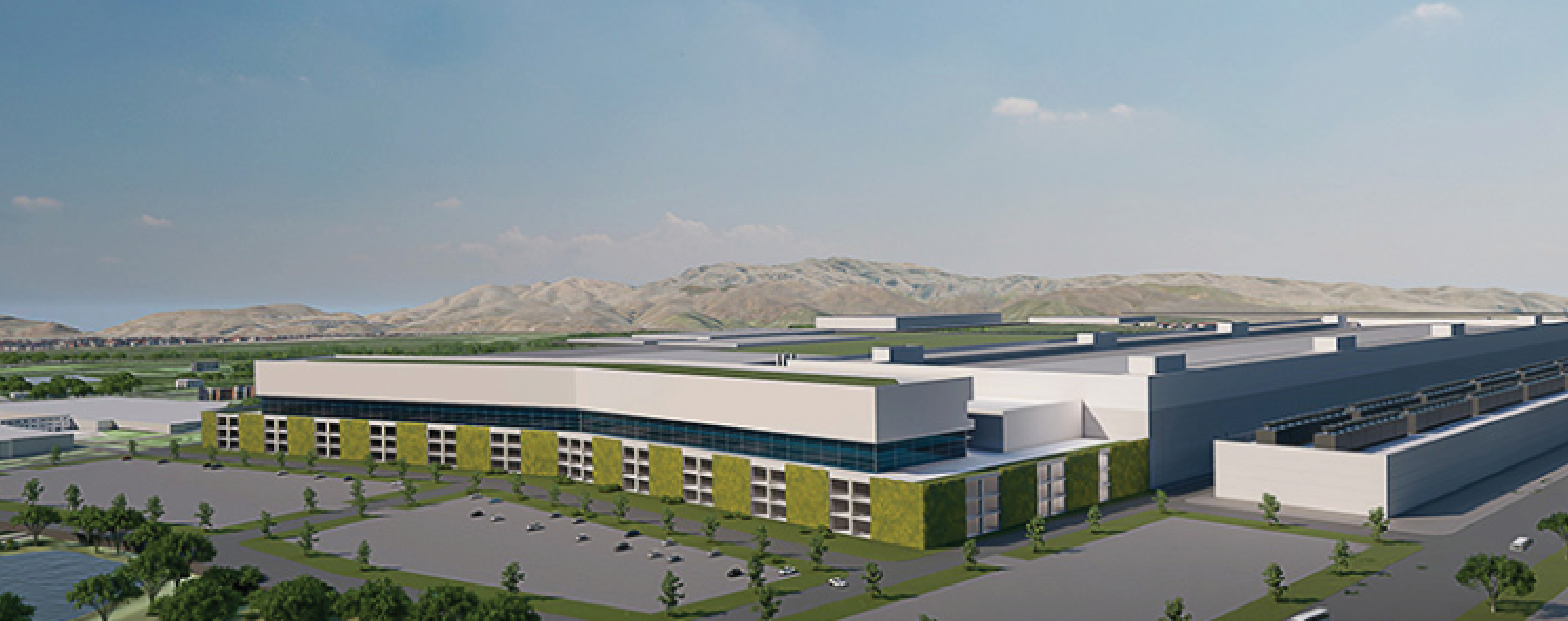 A futuristic, white industrial complex with green accents, surrounded by parking lots and distant mountains