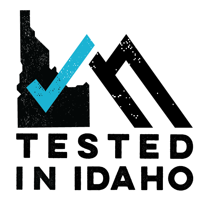 A stylized Idaho state outline with a blue checkmark and 'Tested in Idaho' text
