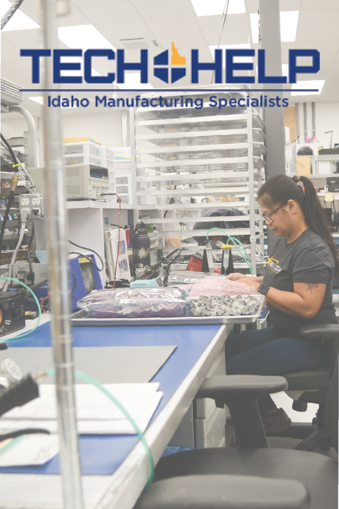 Woman wearing glasses and a black shirt works at a tech manufacturing station