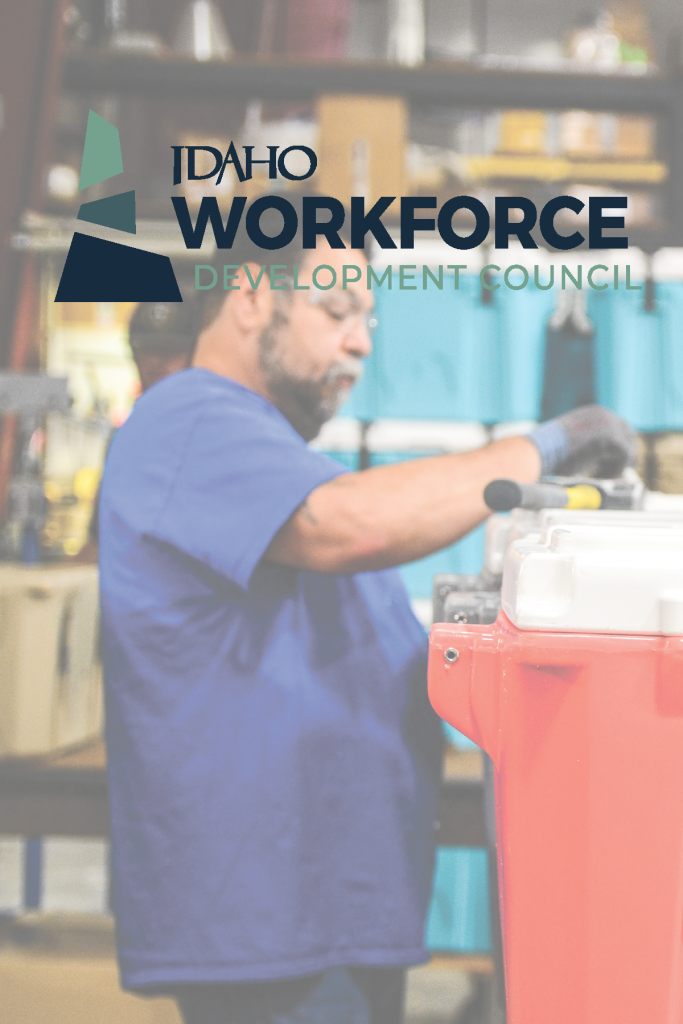 A man in a blue shirt is working with tools in a warehouse setting