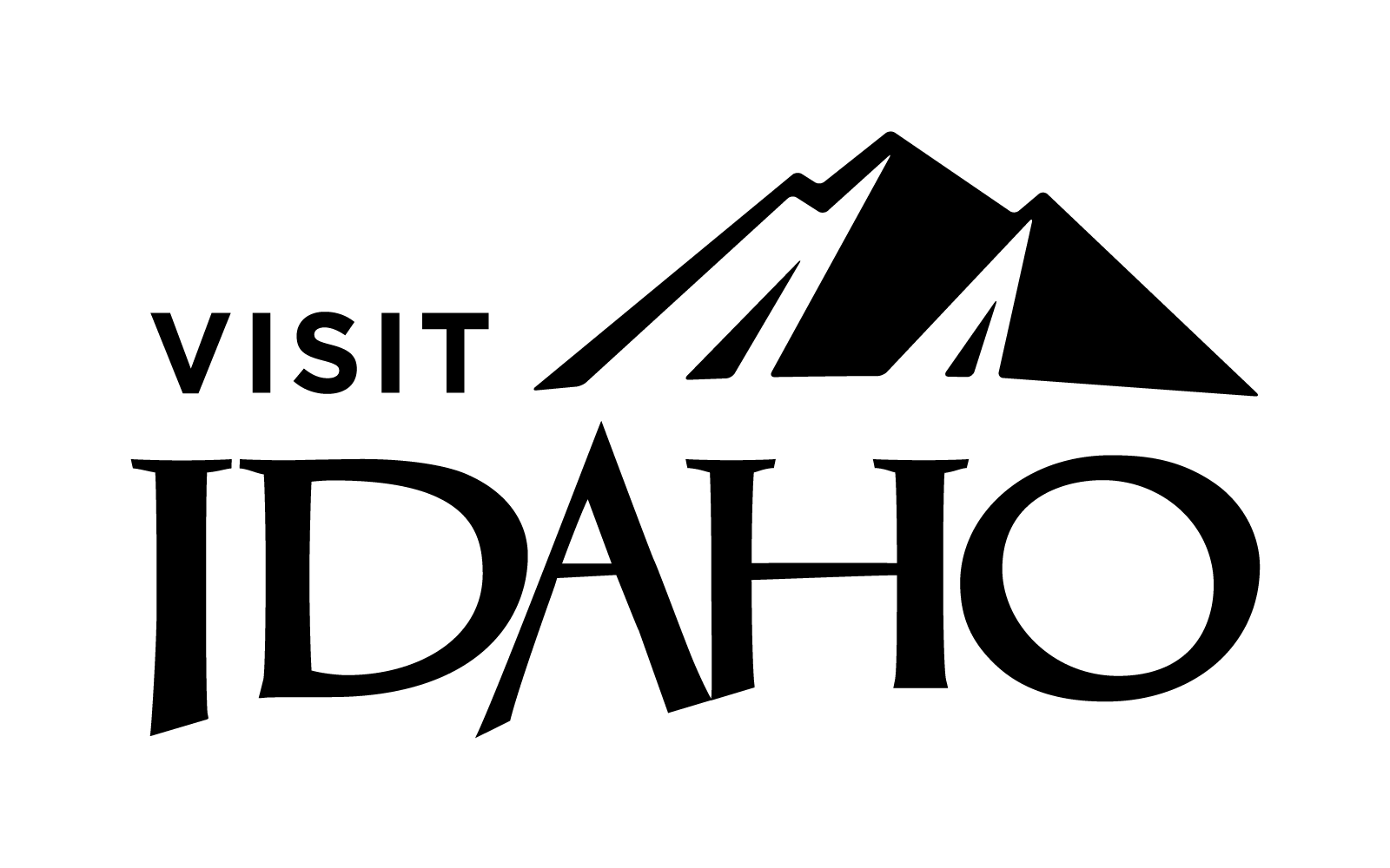 A black cat with green eyes sits on a windowsill, looking out into the night